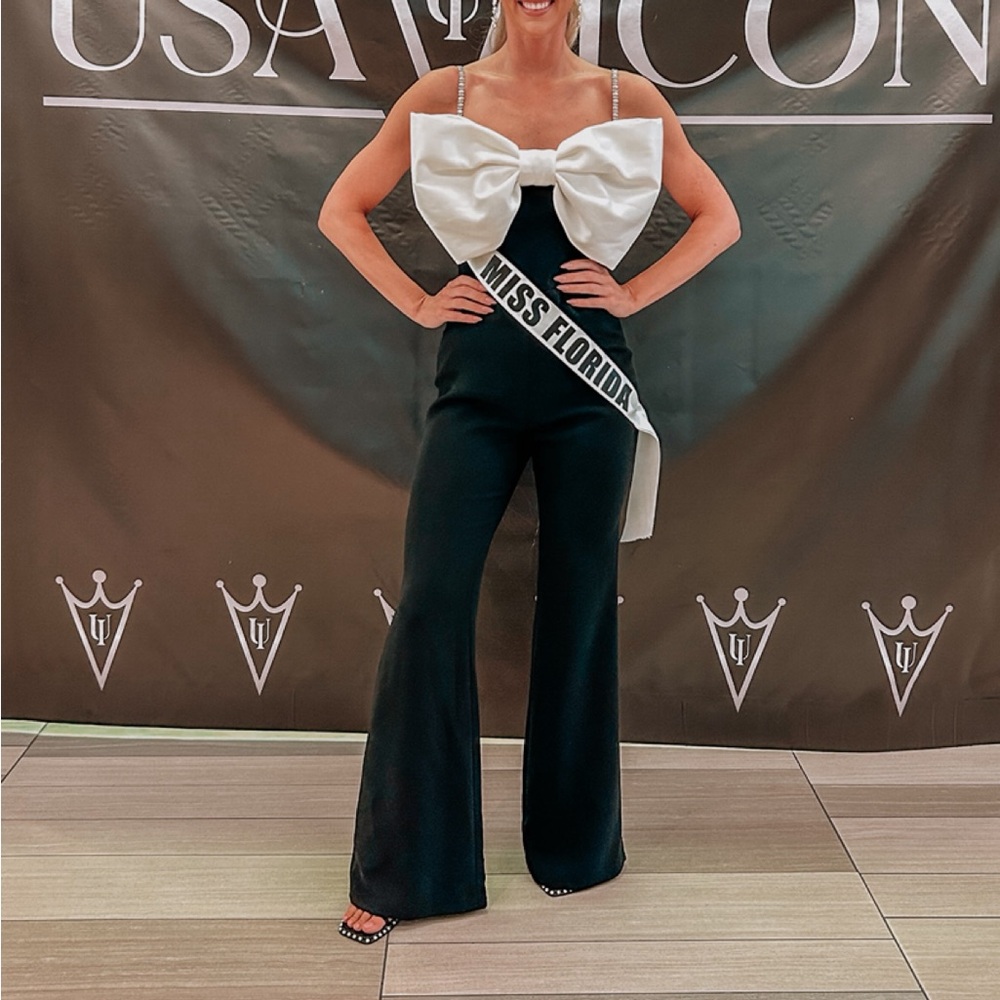 NADINE MERABI Black Jumpsuit with White Bow Accent